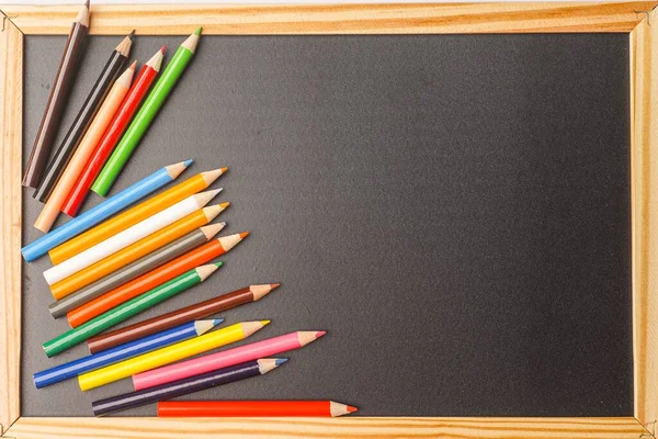 Color Pencils And Piece Of Chalk On A Chalkboard Charcoal Blackboard With  Back To School Written On It With Chalk Stock Photo - Download Image Now -  iStock