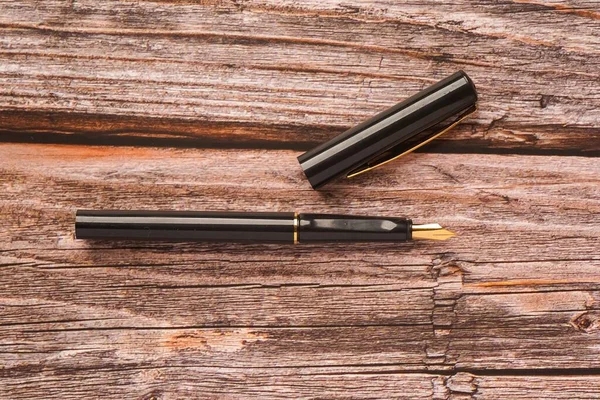 Calligraphy pen isolated on wooden surface