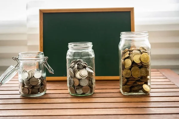 Saving Concept Coins Glass Containers Chalkboard Copy Space — Stock Photo, Image