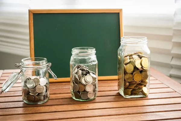 Saving Concept Coins Glass Containers Chalkboard Copy Space — Stock Photo, Image