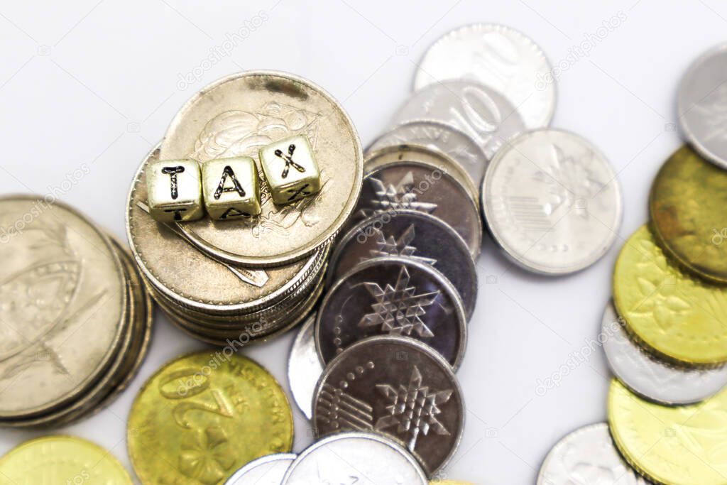 TAX wording on a stack of coins isolated