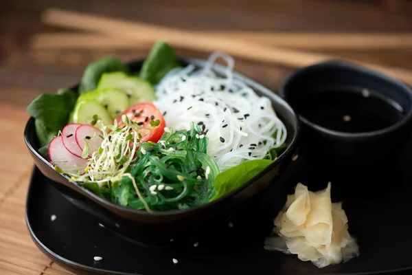 Rice noodles with seaweed, vegetables, herbs and sesame seeds — Stock Image Rice noodles with seaweed, vegetables, herbs and sesame seeds Stock Image