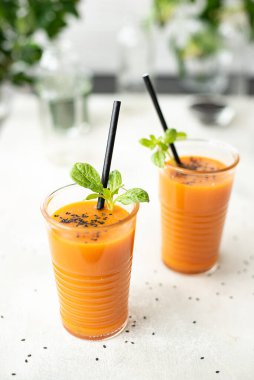 Ispanaklı taze sıkılmış havuç suyu ve cam içinde susam tohumu.