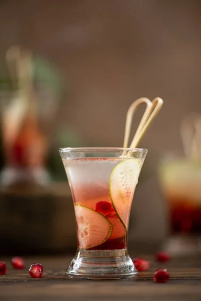 alcohol shot with vodka, lemon juice and pomegranate in small glass
