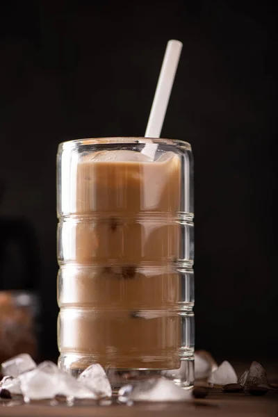 iced black coffee with milk in a tall glass