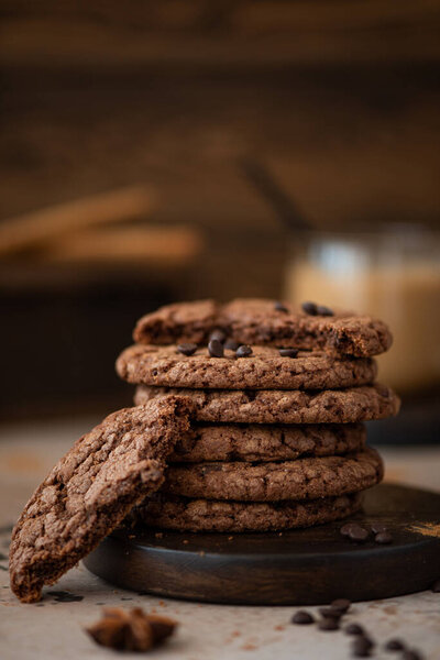 round chocolate chip cookies with almonds on a wooden table