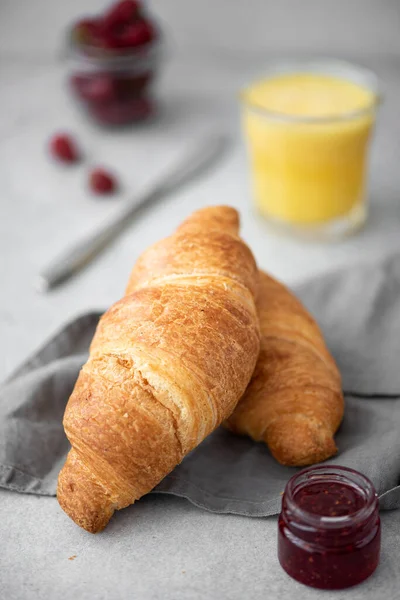Fresh Crunchy Croissants Raspberry Jam Orange Juice Gray Table — Stock Photo, Image