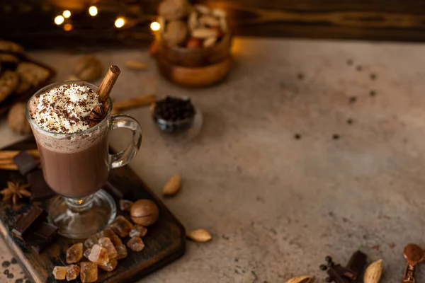 hot chocolate cocoa with whipped cream and grated chocolate in a glass mug