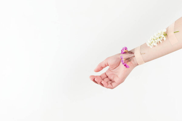 Hand cosmetics with flower and adhesive plasters. Cosmetics for hands anti wrinkle, day spa, beauty salon concept