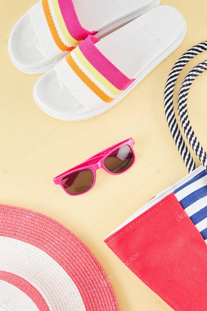 Summer background with straw beach hat, sunglasses and flip flops. Summer travel concept.