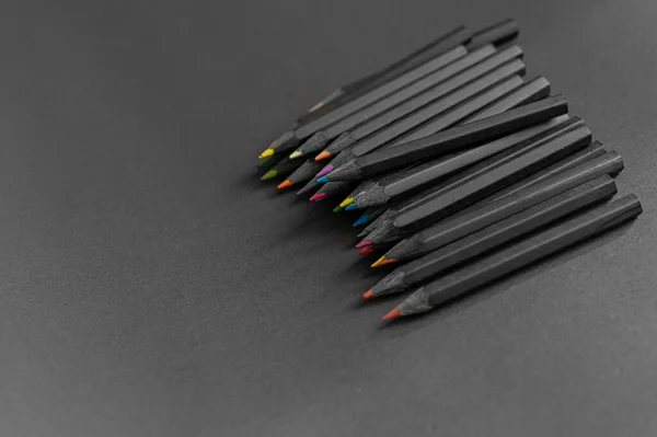 Black pencils. color pencils on dark background. Different color pencils