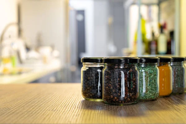 Various spices and herbs in glass jars for cooking, indian spices, multi colored — Stock Photo, Image