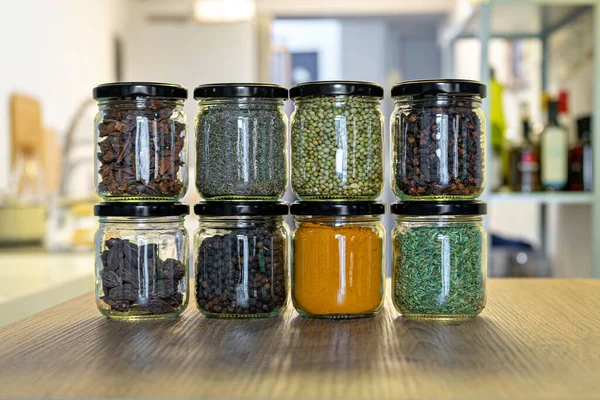 Various spices and herbs in glass jars for cooking, indian spices, multi colored — Stock Photo, Image