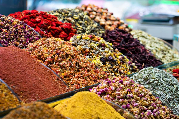 Various bright colored powder spices and fruit herbal tea and dried vegetables on market in Istanbul, Turkey.