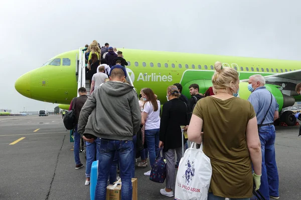 Bir S7 uçağına binen yolcular, Domodedovo havaalanından yukarı çıkın. Rusya, Moskova Domodedovo Temmuz 2020         