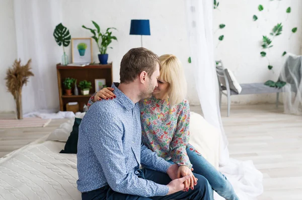 Sarılma ve evde yatakta rahatlatıcı sevgi dolu genç çift.