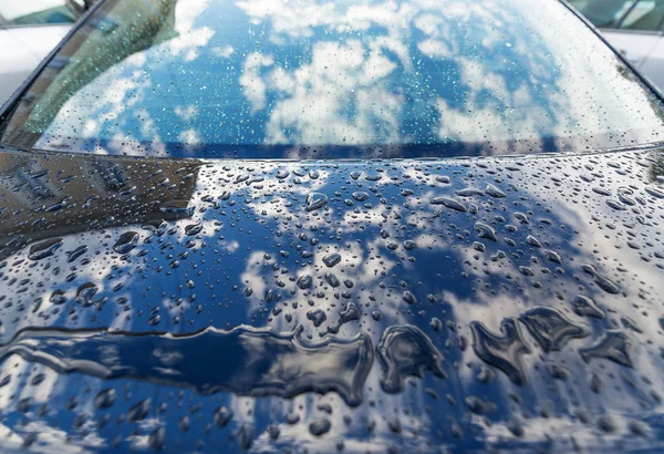 Raindrops on a car surface. Fancy drawings of a rain on the metal surface of the car