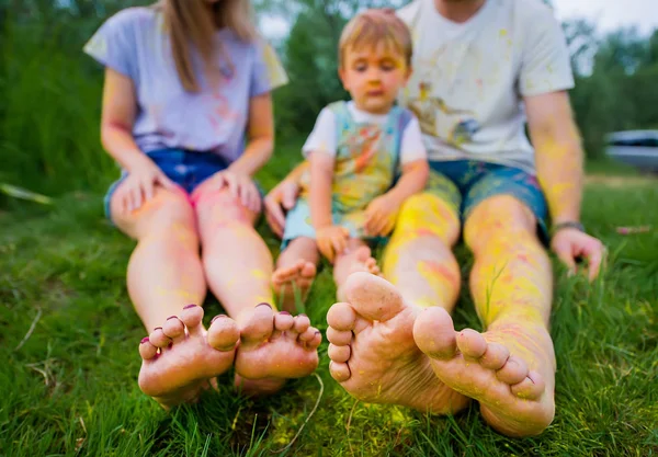 Gelukkige familie in veelkleurige verven slenteren op zomer weide. Selectieve focus op tenen — Stockfoto