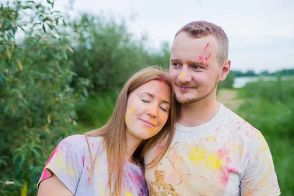 Coppia romantica in vernici multicolori che si abbracciano nel prato estivo . — Foto Stock
