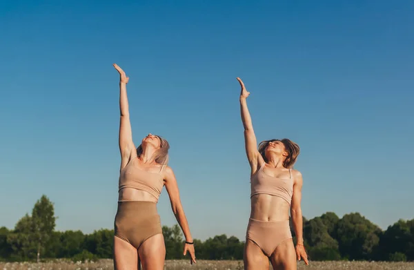 Duas Mulheres Esportivas Levantando Mãos Sobre Campo Grama Dia Verão — Fotografia de Stock