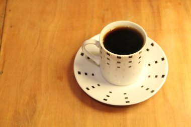 Ahşap arka planda bir fincan dolusu kahve manzarası