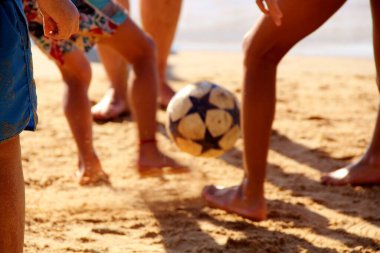 Kumsalda futbol oynayan insanların bacaklarına bakın. 