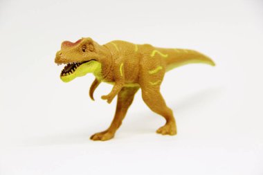 Beyaz arka planda izole edilmiş plastik dinozor oyuncağı
