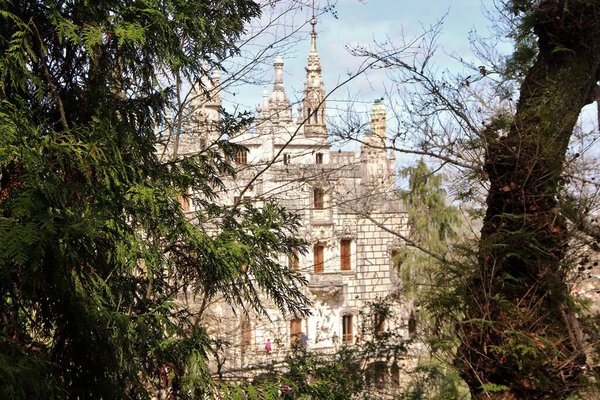 View of architecture, facades of buildings, and garden of the palace complex Quinta da Regaleira, Sintra, Portugal