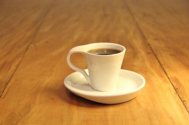 Ahşap arka planda bir fincan dolusu kahve manzarası