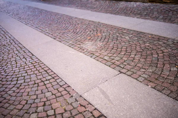 cobblestones with crosswalks on city background