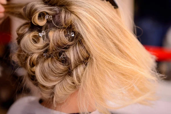 Hair styling of bride\'s hair before the wedding