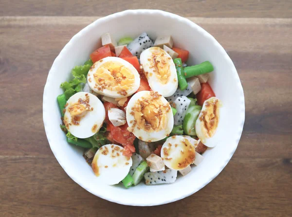 Diet menu. Healthy salad of fresh vegetables and egg on a bowl