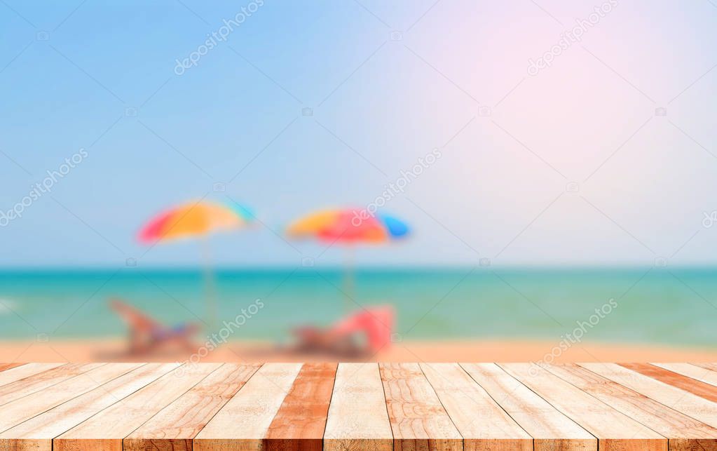 Close up wooden plank with blurred beach background use for products or something you want to display