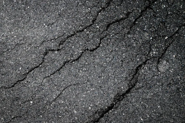 Dark asphalt crack by earthquake — Stock Photo, Image