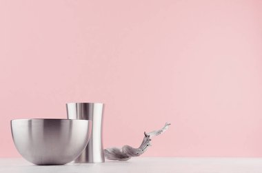 Contemporary decoration for minimalistic design interior with silver polished geometric bowls, old shabby twig on white wood table, pastel pink wall. clipart