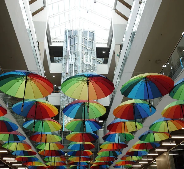 Rainbow umbrella on the background of the supermarket. Many multi-colored umbrellas. umbrella decoration in store. copyspace.