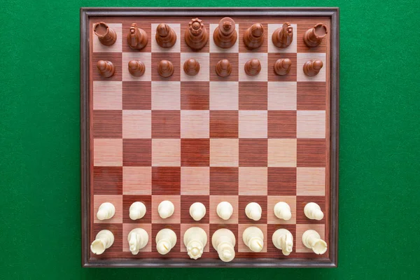 Image of chess on a green background. World Chess Day.  International Chess Day. July 20. View from above.