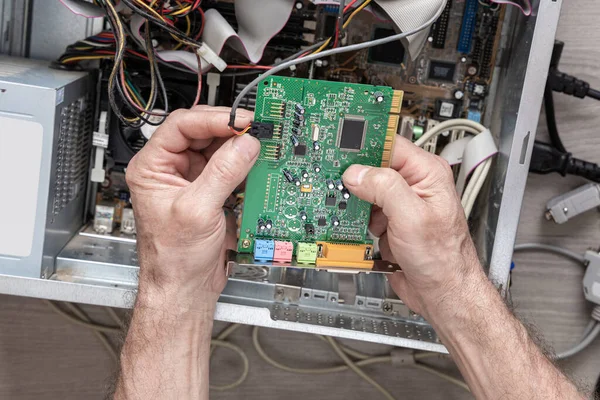 Repairing and assembling a desktop computer. Professional man repairing and assembling a desktop computer. Desktop computer. installation. Top view.