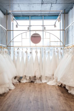 Mağazadaki askılarda asılı güzel beyaz gelinlikler