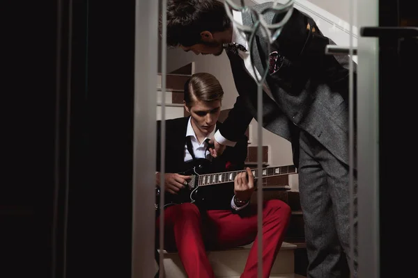 Handsome Man Red Trousers Black Jacket Sitting Stairs Playing Guitar — Stock Photo, Image