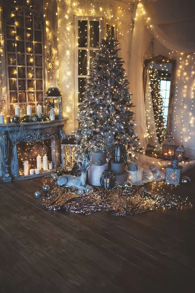 Warm and cozy evening in Christmas room, interior design, Christmas tree decorated with lights, living room.magic in new year