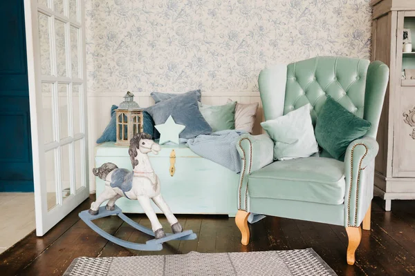Bright room in pastel gray colors with an armchair