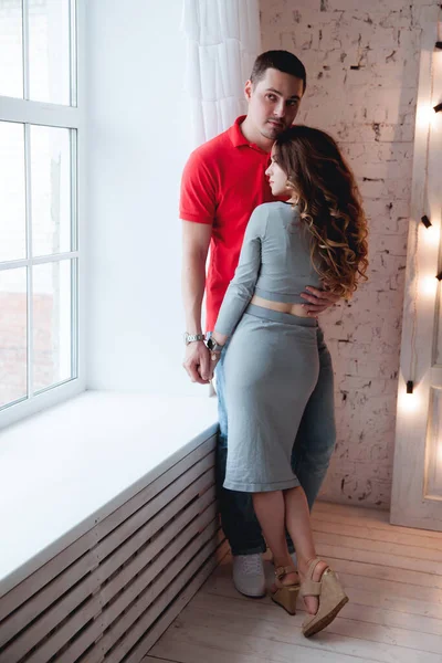 Young Couple Hugging Window Home — Stock Photo, Image