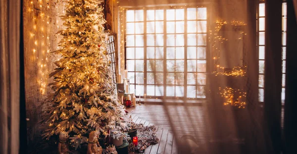 豪華なクリスマスルームのインテリアデザイン黄金 ライトで飾られたクリスマスツリーは 贈り物 キャンドル ランタン ガーランド照明暖炉 休日のリビングルームを提示します 年末年始 — ストック写真