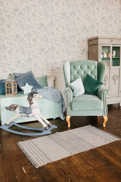 Bright room in pastel gray colors with an armchair