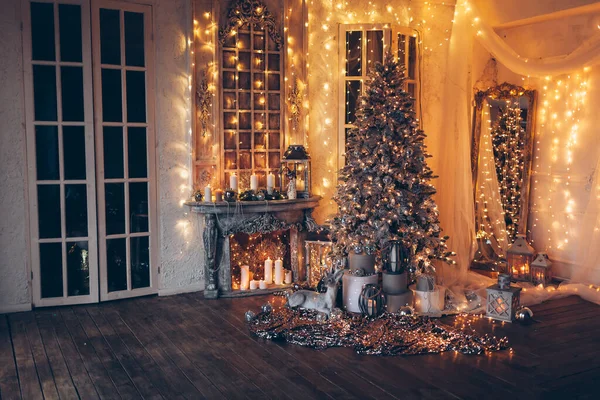 Warm and cozy evening in Christmas room, interior design, Christmas tree decorated with lights, living room.magic in new year