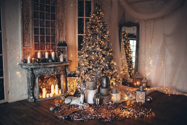 Warm and cozy evening in Christmas room, interior design, Christmas tree decorated with lights, living room.magic in new year