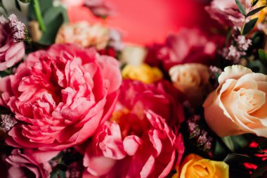 Kırmızı arka planda renkli çiçekleri olan güzel bir buket.