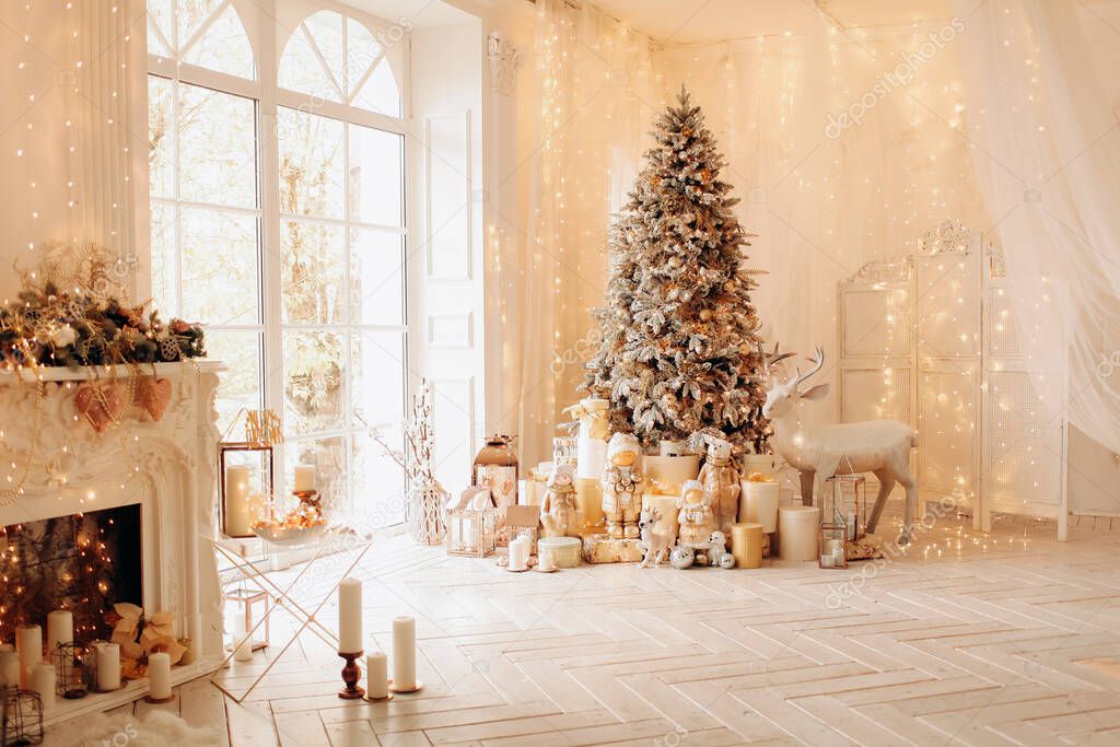 Warm and cozy morning in Christmas interior design, Xmas tree decorated by lights presents, gifts, toys, deer, candles, lanterns, garland lighting, indoors fireplace.