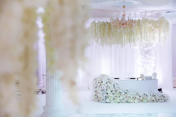 interior of wedding room with furniture and white flowers